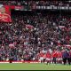 MANCHESTER, ENGLAND - MAY 17: Michael Carrick, Manager of Manchester United, speaks to the fans as a banner tribute to Casemiro of Manchester United is seen in the stands following the Premier League match between Manchester United and Nottingham Forest at Old Trafford on May 17, 2026 in Manchester, England.