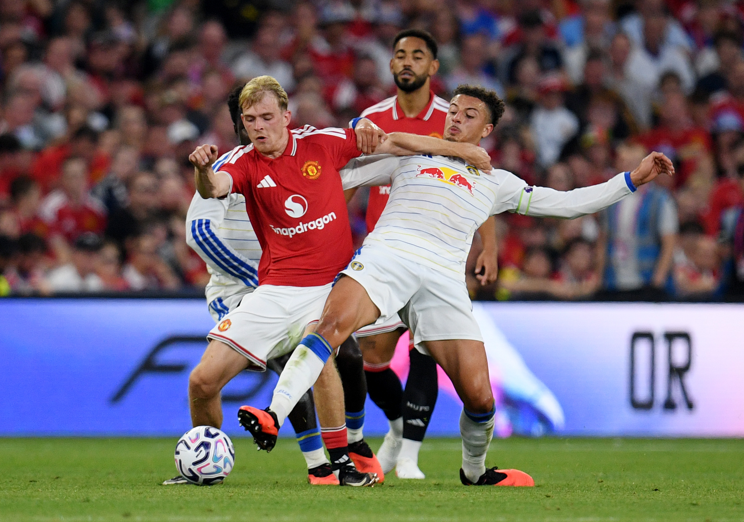 DUBLIN, IRELAND - AUGUST 12: Toby Collyer of Manchester United is challenged by Ethan Ampadu of Leeds United during the pre-season friendly match between Leeds United and Manchester United at Croke Park on August 12, 2026 in Dublin, Ireland.