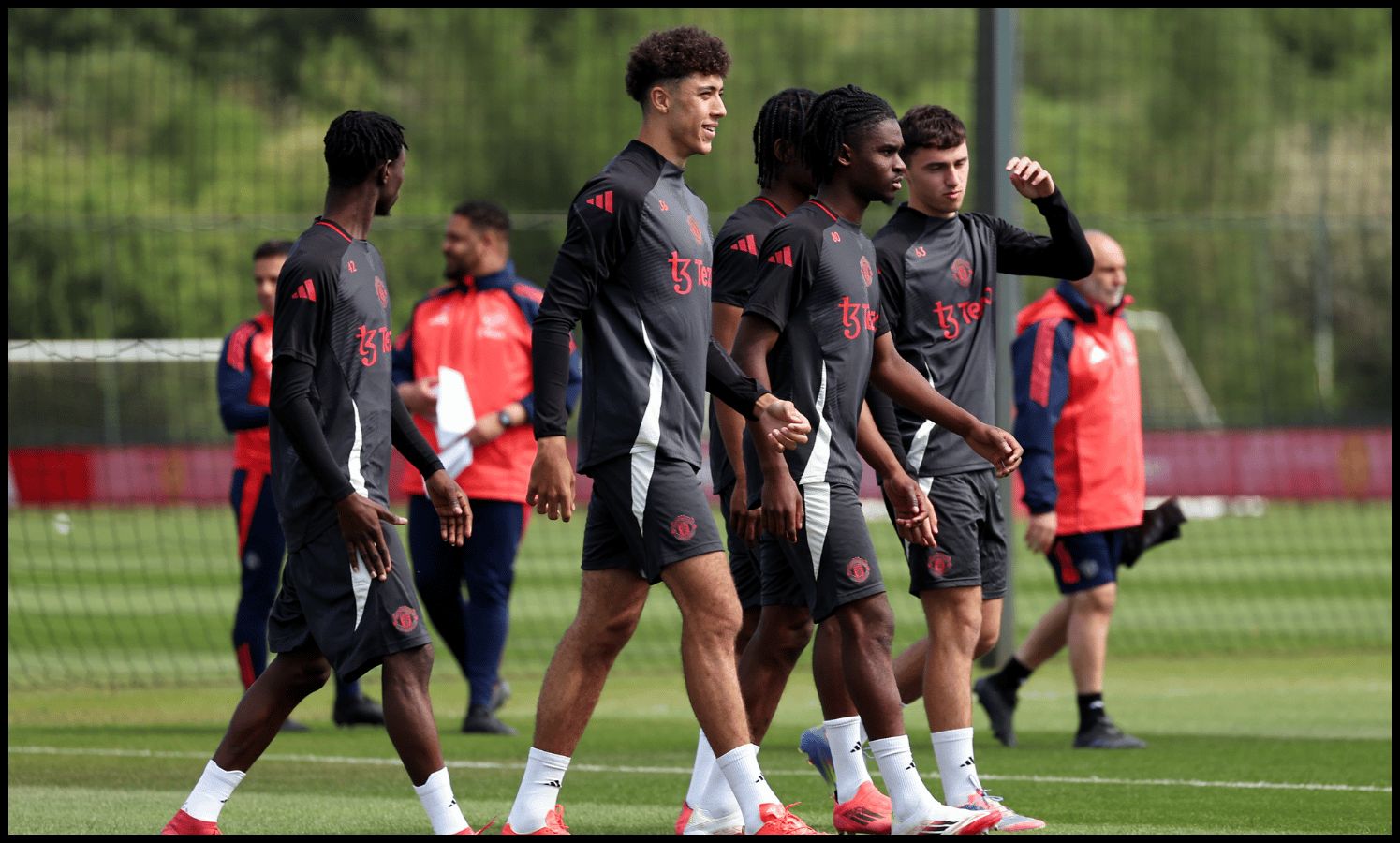 MANCHESTER, ENGLAND - MAY 14: Ethan Wheatley of Manchester United walks to the pitch with teammates during a training session at Carrington Training Ground on May 14, 2025 in Manchester, England