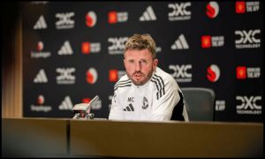 Michael Carrick talks at a press conference