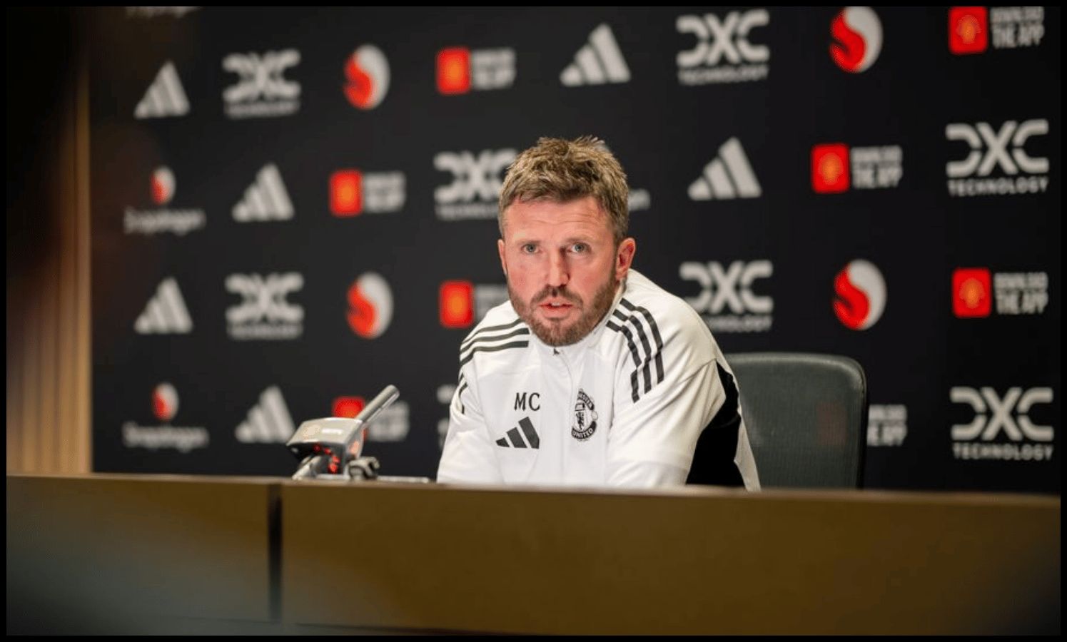 Michael Carrick talks at a press conference