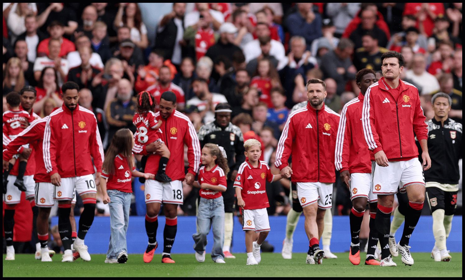 MANCHESTER, ENGLAND - AUGUST 30: Harry Maguire of Manchester United walks out onto the pitch with teammates before the Premier League 2026/27 match between Manchester United and Ipswich Town at Old Trafford on August 30, 2026 in Manchester, England.