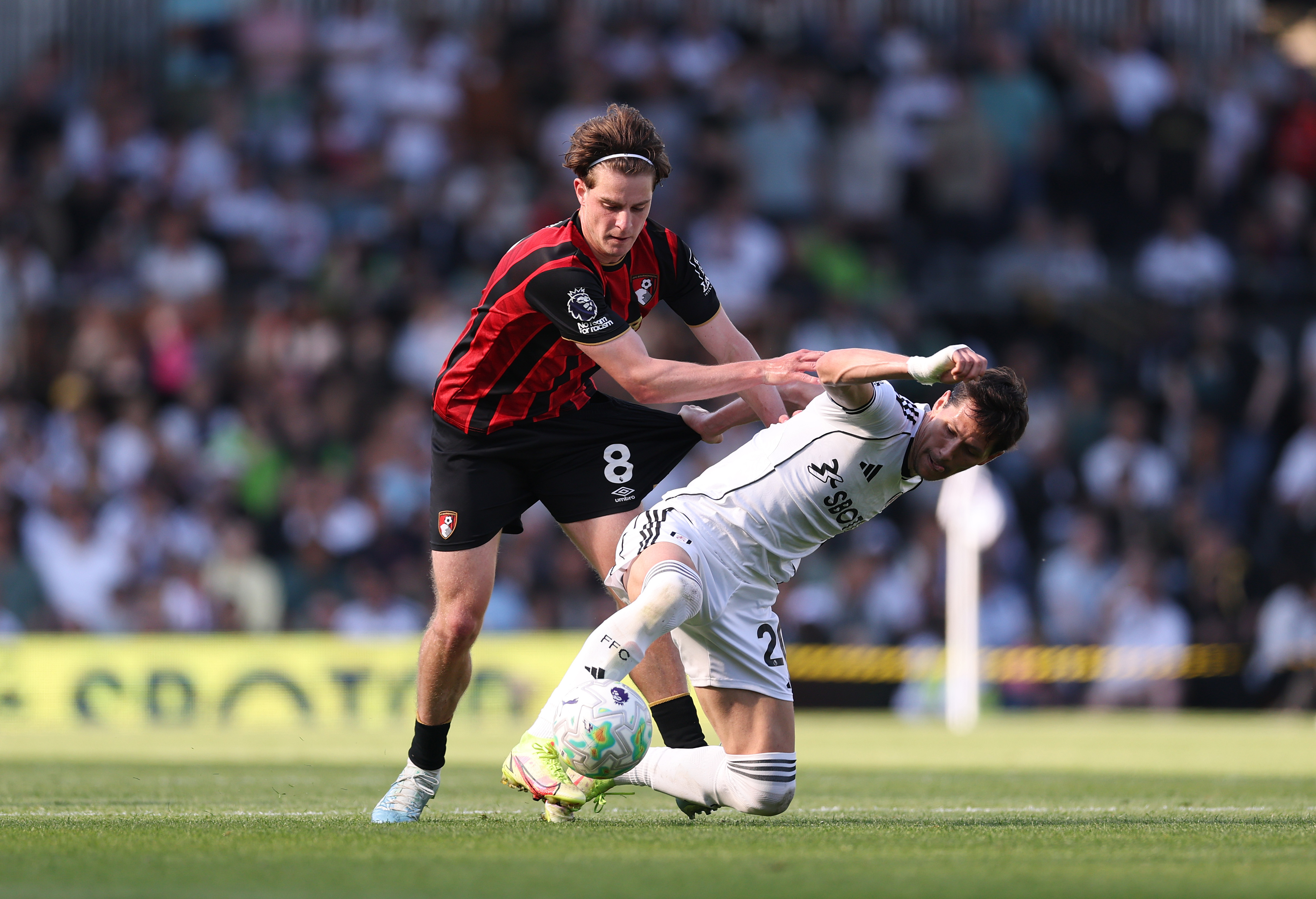 LONDON, ENGLAND - MAY 09: Sasa Lukic of Fulham is challenged by Alex Scott of AFC Bournemouth during the Premier League match between Fulham and Bournemouth at Craven Cottage on May 09, 2026 in London, England.