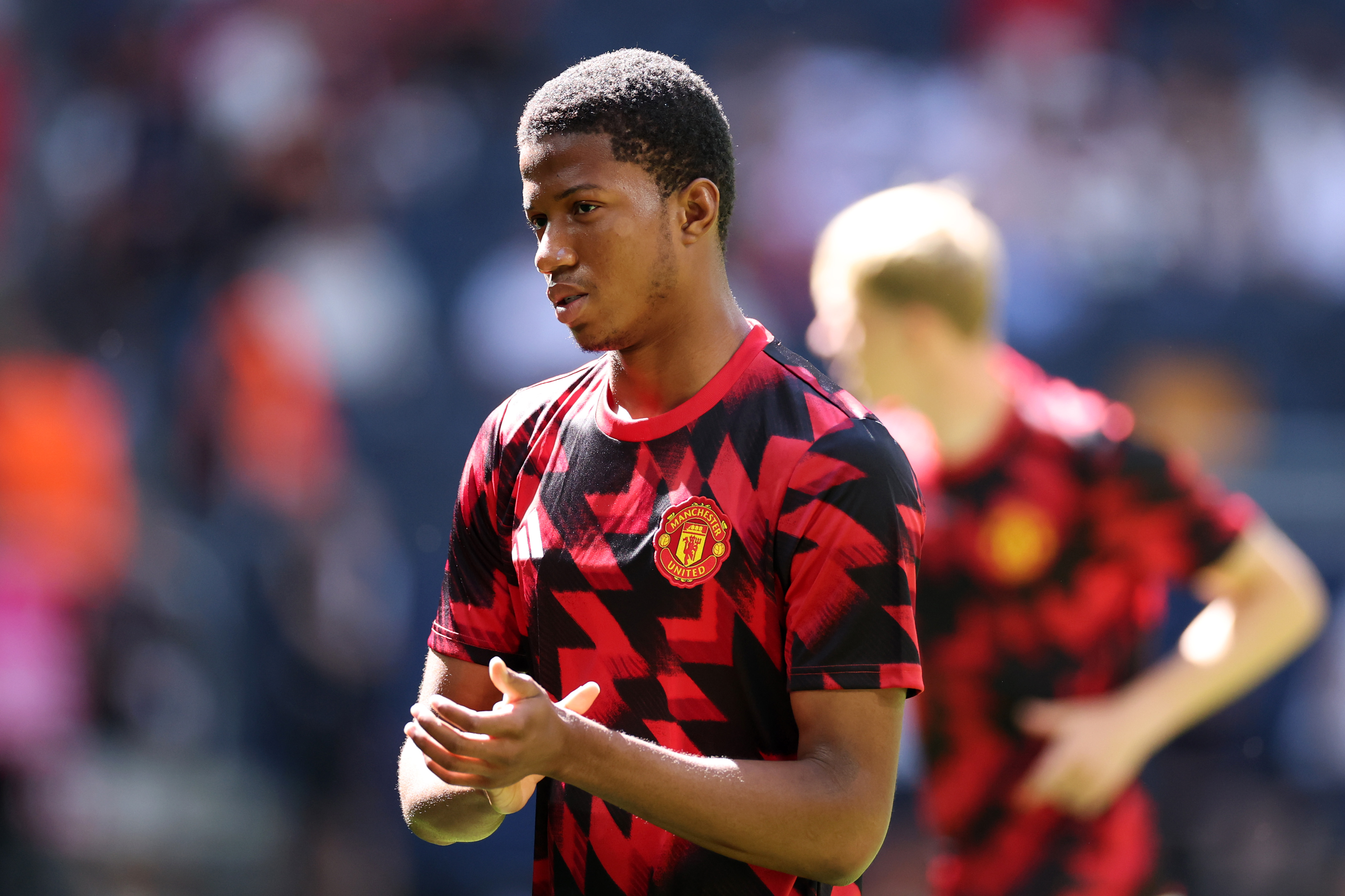 SOLNA, SWEDEN - JULY 19: Chido Obi of Manchester United applauds the fans during the warm up prior to the pre-season friendly match between Manchester United and Leeds United at Strawberry Arena on July 19, 2025 in Solna, Sweden.
