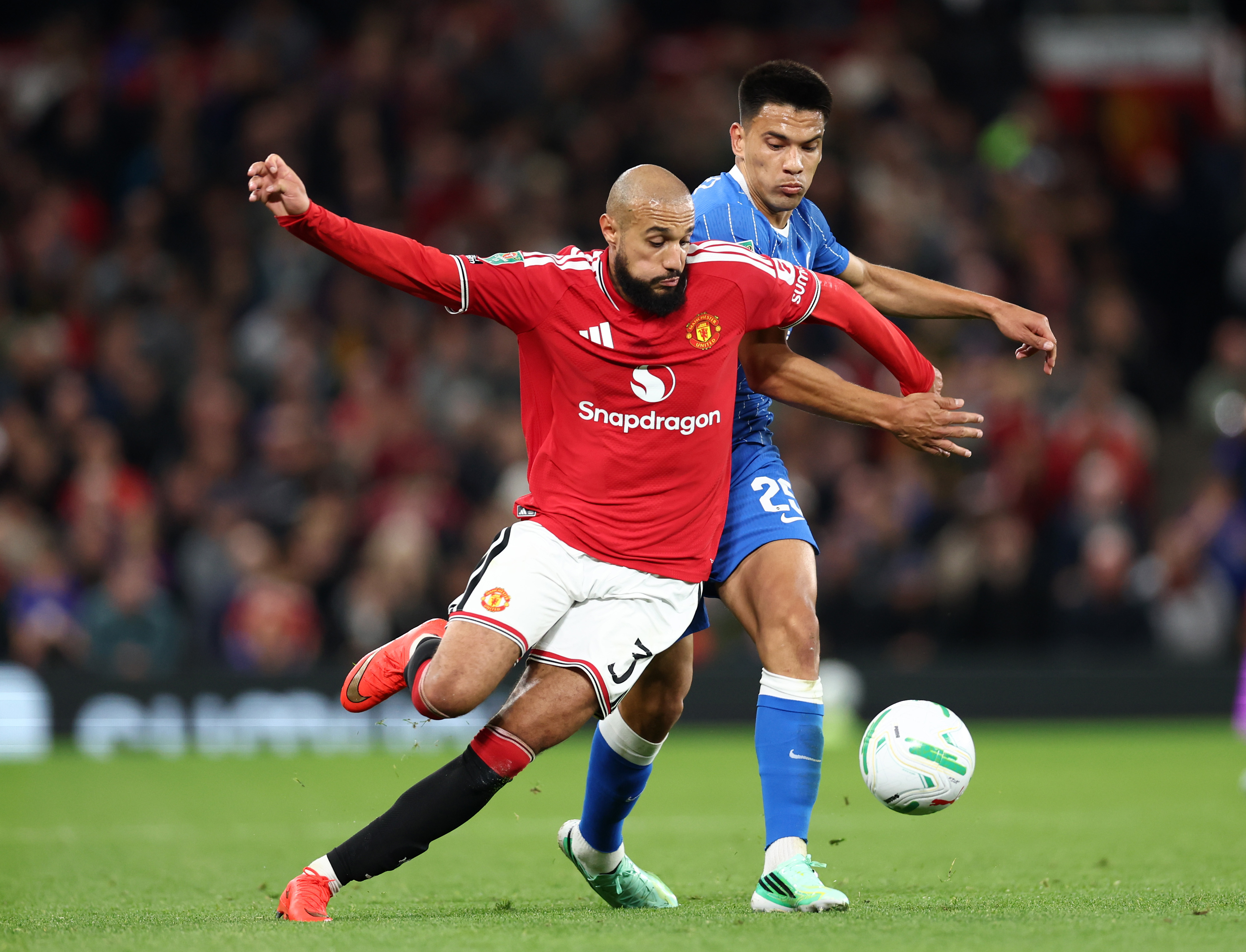 MANCHESTER, ENGLAND - SEPTEMBER 16: Noussair Mazraoui of Manchester United in action with Diego Gomez of Brighton & Hove Albion during the Carabao Cup Third Round match between Manchester United and Brighton & Hove Albion at Old Trafford on September 16, 2026 in Manchester, England. (Photo by Molly Darlington/Getty Images)