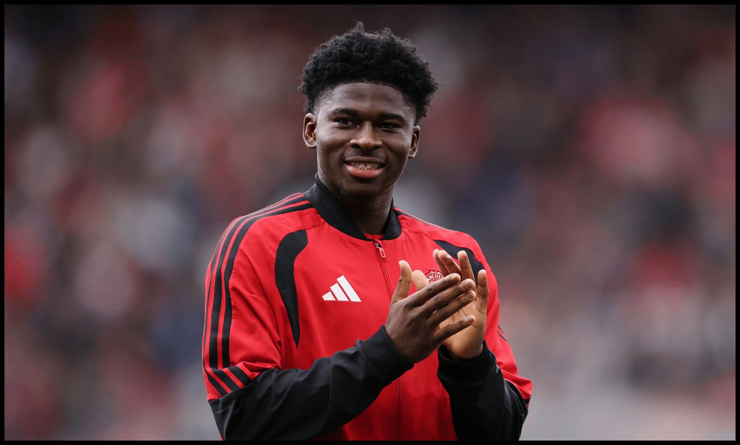 MANCHESTER, ENGLAND - AUGUST 30: New signing Carlos Baleba of Manchester United acknowledges the fans as he is introduced before the Premier League 2026/27 match between Manchester United and Ipswich Town at Old Trafford on August 30, 2026 in Manchester, England