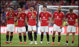 Manchester United players looking on