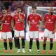 Manchester United players looking on